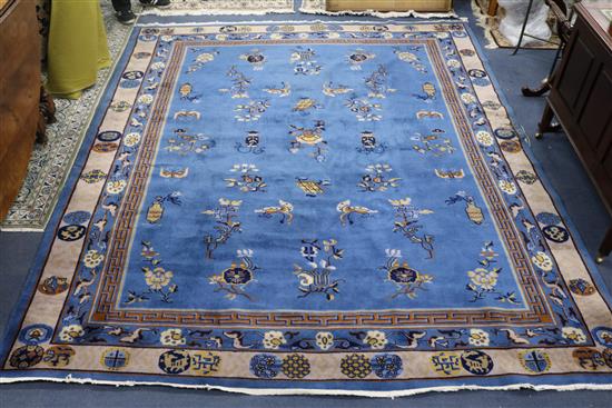 A Chinese dark blue ground carpet 292 x 249cm